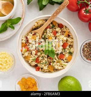 Close-up of a tabbouleh dish with surrounding ingredients Stock Photo