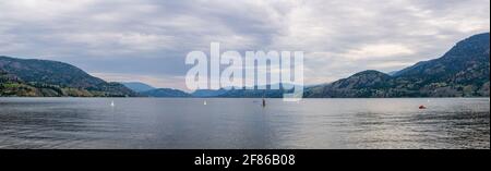 PENTICTON, CANADA - JULY 3, 2020: recreation time paddle boarding on scenic peaceful mountain lake. Stock Photo