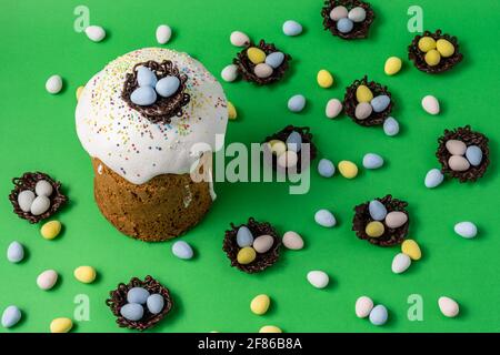 Easter Cakes or Paska and eggs composition on green background. Stock Photo