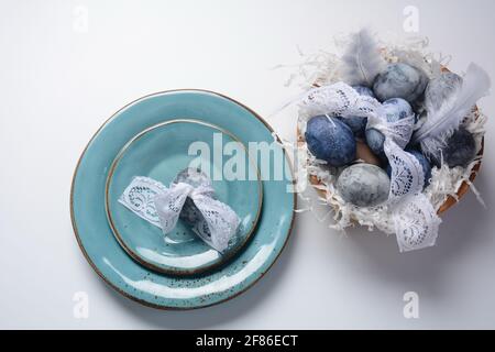 Easter table setting.  Decorated Easter eggs  in an Easter basket Stock Photo