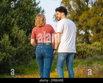 Back view of a happy Spanish couple spending leisure time together Stock Photo