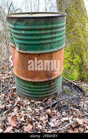 old rusty oil barrel dumped Swedish forest Stock Photo