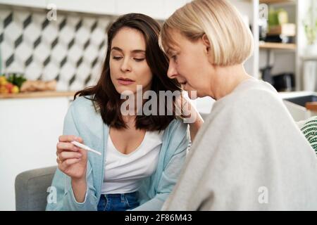 Woman with negative pregnancy test with a supportive mother Stock Photo