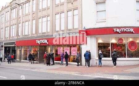 Brighton, UK. 12th Apr, 2021. Shoppers queue outside the TKMax store in Brighton this morning as the next stage of lockdown easing begins in England with non essential shops opening up for the first time in months : Credit: Simon Dack/Alamy Live News Stock Photo