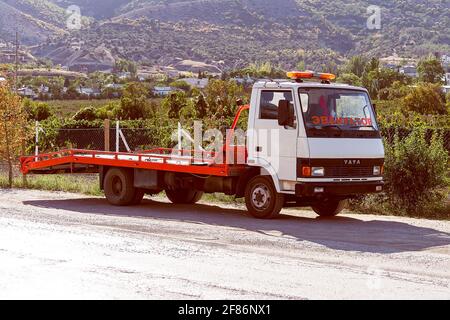 Car is tow truck on side of road and inscription in Russian language EVACUATOR, Crimea, Sudak - 10 October 2020. Stock Photo