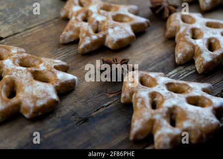 Christmas cookies in the shape of a Christmas tree. New Year's food. Anise star. Festive baked goods. Gingerbread on the table. Pattern. Stock Photo