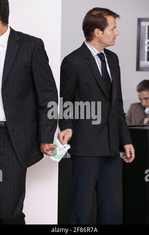 Businessmen exchanging money secretly in office Stock Photo