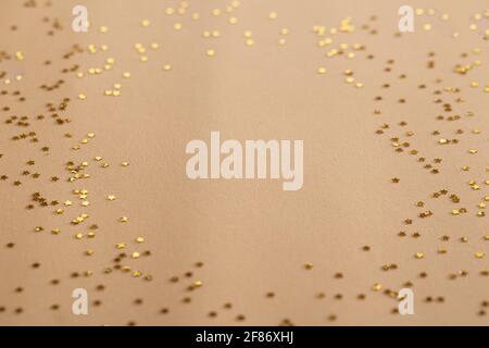 Golden sparkles stars on gold holiday background. Festive backdrop for your projects Stock Photo