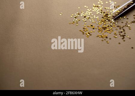 Golden sparkles stars on gold holiday background. Festive backdrop for your projects Stock Photo
