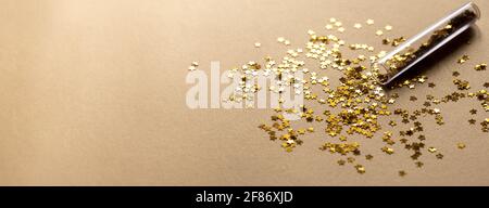 Golden sparkles stars on gold holiday background. Festive backdrop for your projects Stock Photo