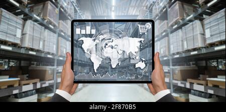 Hands with digital tablet on the background of a warehouse. Online trade and logistics concept Stock Photo
