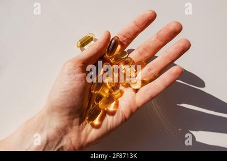 Woman's hand close-up holding a lot of gel pills Stock Photo