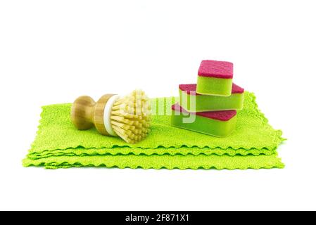Multicolored cleaning sponges and dish brushes on microfiber cloth isolated on a white background. House cleaning supplies Stock Photo