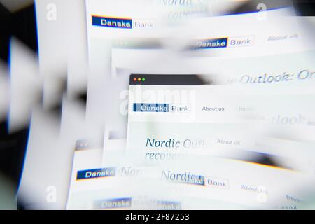 Milan, Italy - APRIL 10, 2021: Danske Bank logo on laptop screen seen through an optical prism. Illustrative editorial image from Danske Bank website. Stock Photo