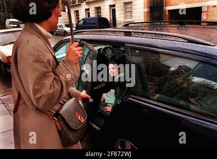 Being collected by car from The Cavendish school in Camden, Louisa O'Connell (9) with mum Irene O'Connell who collects her every day. Stock Photo