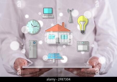 Smart home concept above a tablet held by a man in background Stock Photo