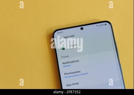 New york, USA - April 12, 2021: Changing privacy setting in Microsoft excel app on smartphone screen in yellow background Stock Photo