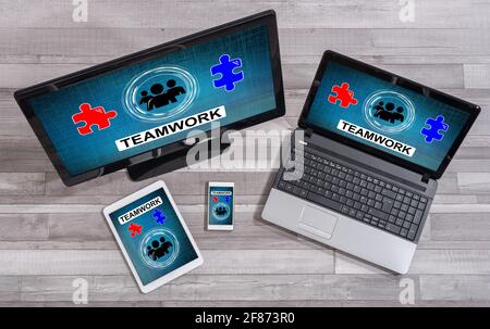 Teamwork concept shown on different information technology devices Stock Photo