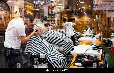 Brighton UK 12th April 2021 - It's good to get a close shave and haircut in Brighton this morning as the next stage of lockdown easing begins in England with non essential shops and businesses opening up for the first time in months : Credit Simon Dack / Alamy Live News Stock Photo
