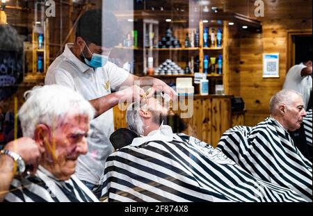 Brighton UK 12th April 2021 - It's good to get a close shave and haircut in Brighton this morning as the next stage of lockdown easing begins in England with non essential shops and businesses opening up for the first time in months : Credit Simon Dack / Alamy Live News Stock Photo