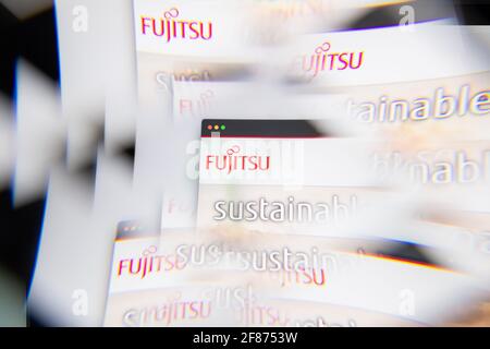 Milan, Italy - APRIL 10, 2021: Fujitsu logo on laptop screen seen through an optical prism. Illustrative editorial image from Fujitsu website. Stock Photo
