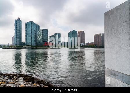 New York City, USA - June 24, 2018: View of Hunters Point New Development Area and Pepsi Cola Sign in Long Island from Roosevelt Island. Foggy day in Stock Photo