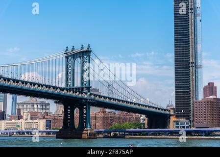 New York City, USA - June 24, 2018: Manhattan Bridge and cityscape from East River. Iconic view of NYC Stock Photo