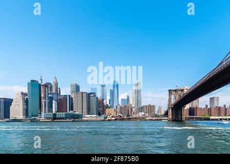 New York City, USA - June 24, 2018: Brooklyn Bridge and cityscape of Downtown from East River. Iconic view of NYC Stock Photo