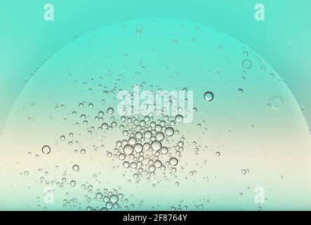 Circular globular oil bubbles floating on the surface of of green tinted water creating a random pattern with copyspace for a design template Stock Photo