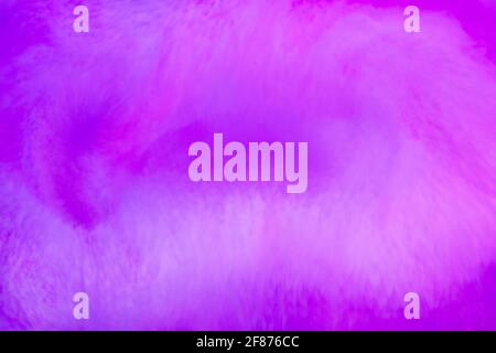 Purple through magenta blend of swirling ink or pigment in a monochromatic abstract background pattern suitable for a design template Stock Photo