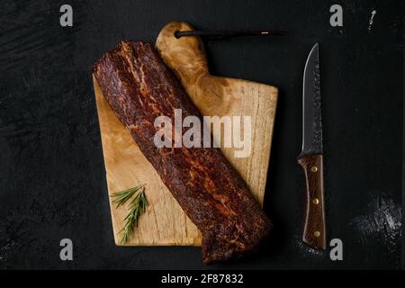 Top view of smoked beef striploin meat on cutting board Stock Photo