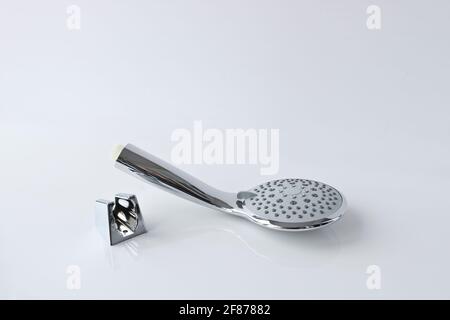 Shower head and wall mount on a light background. Plumbing accessories. Stock Photo