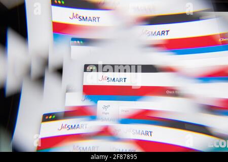 Milan, Italy - APRIL 10, 2021: JetSmart logo on laptop screen seen through an optical prism. Illustrative editorial image from JetSmart website. Stock Photo