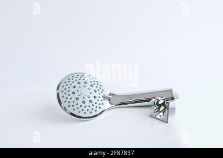 Shower head and wall mount on a light background. Plumbing accessories. Stock Photo