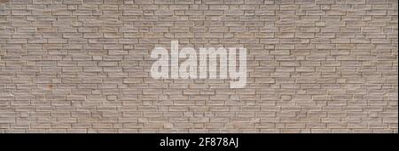 Bright old wall made of concrete bricks in the sunlight Stock Photo