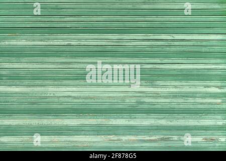 Old green roller blind made of weathered wood Stock Photo