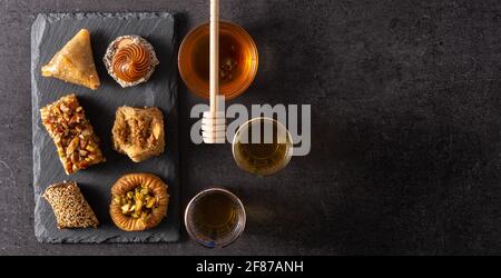 Assortment of Ramadan dessert baklava on black background Stock Photo