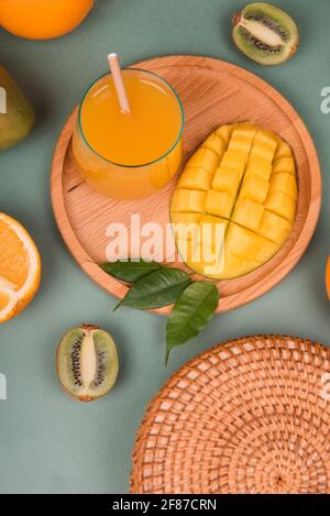 Glass of orange and mango juice on wooden plate Stock Photo