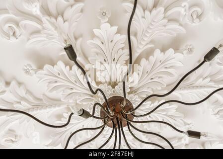 Stucco ornament above elegant chandelier Stock Photo