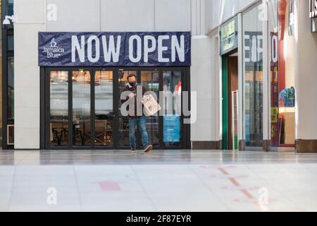 Cambridge, UK. 12th Apr, 2021. Shops reopen in Cambridge as part of the UK easing of Covid 19 lockdown restrictions. The roadmap allows opening of non essential shops across England today. It was a relatively quiet start to the morning as shoppers returned to high Street retail outlets. Credit: Julian Eales/Alamy Live News Stock Photo