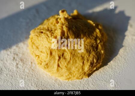 Bread dough or cookie baking in kitchen on white table in sunset sunlight. Baking, tasty cookies or Easter pastry making concept. Top view. High quality photo Stock Photo