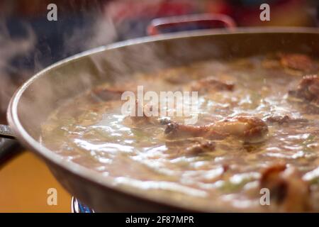 Paella being cooked. Traditional spanish food. Valencia, Spain. Stock Photo