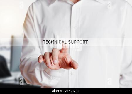 Businessman presses on virtual touch screen with the words technical support. Customer assistance or service concept. Stock Photo
