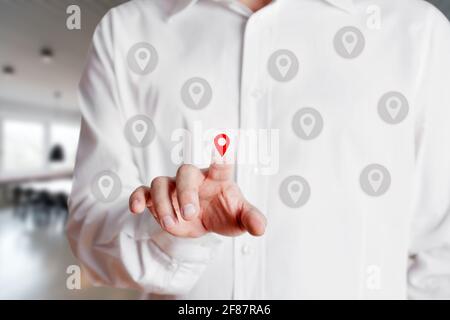 Businessman presses on and selects a location or map pin icon on virtual touch screen. Map pointer navigation concept Stock Photo
