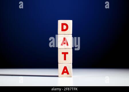 The word data written on tiered wooden cubes against blue background. Stock Photo