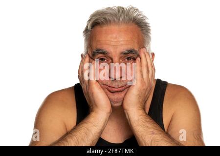 Sad and bored unshaven middle aged man with short gray hair Stock Photo