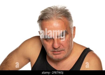 middle aged angry man with short gray hair on white background Stock Photo