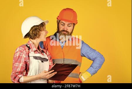 engineers couple working together on building blueprint. work at construction site or factory. Civil engineering. industrial business partner. job and Stock Photo