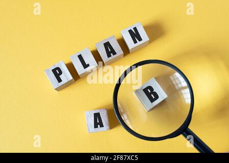 Magnifying zoom on Plan B against yellow background. Concept of Strategy, business management and option Stock Photo