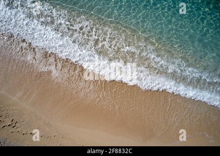 Top view of sea waves splashing on tropical beach. Stock Photo
